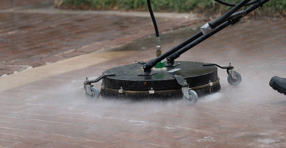 Pressure Washer Cleaning Red Brick Pavement — Zac's Bin and Pressure Cleaning In Parramatta Park, QLD