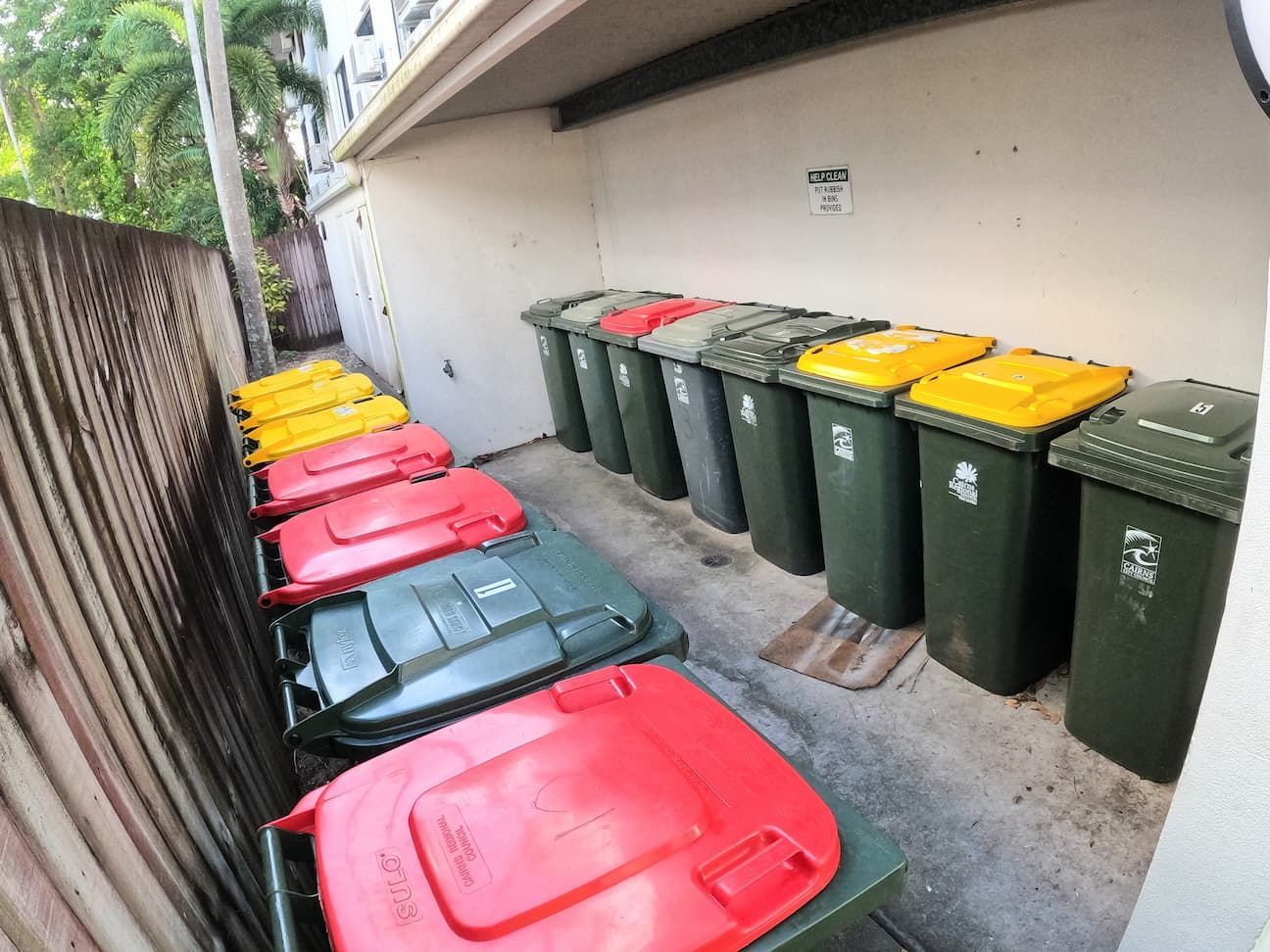 A Bunch of Trash Cans Are Lined up In a Row — Zac's Bin Cleaning & Pressure Washing Services In Parramatta Park, QLD