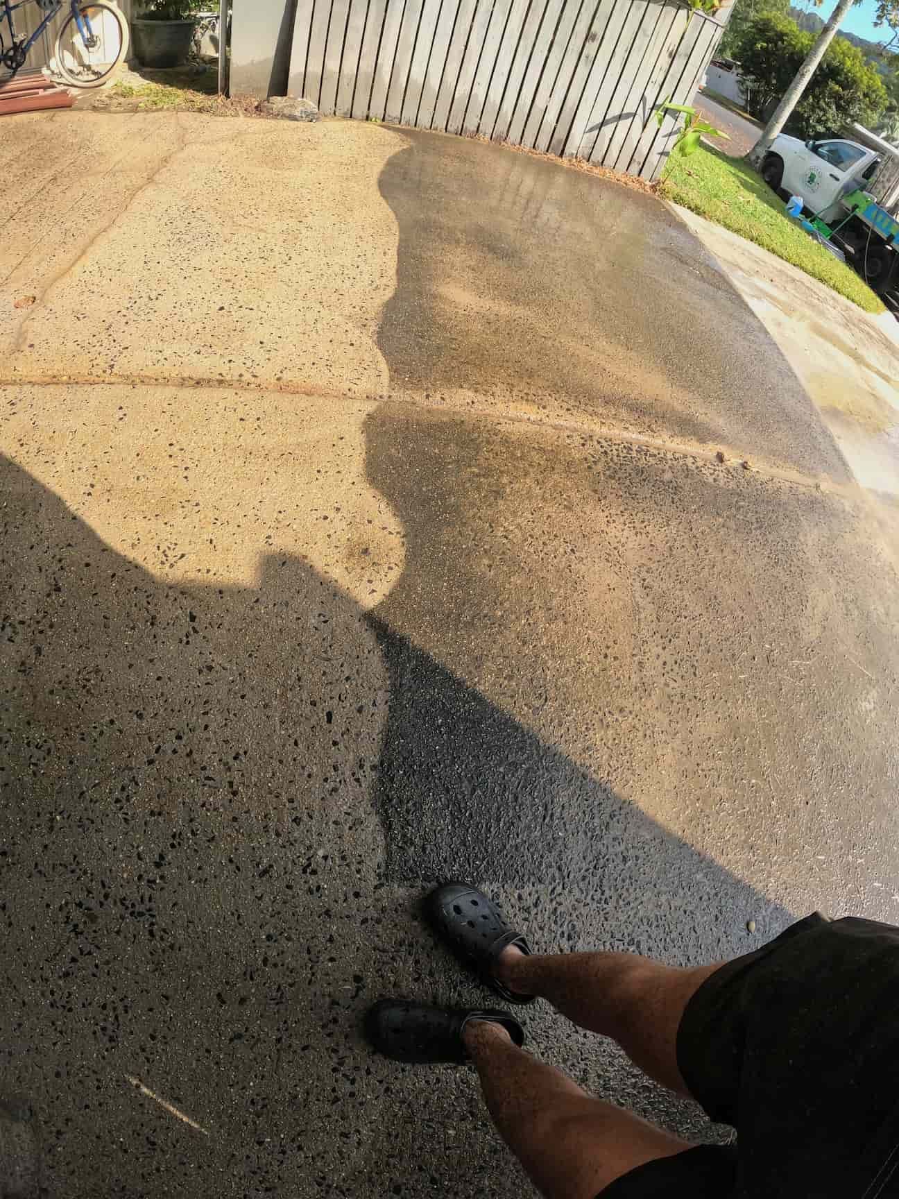 A Person Is Standing on A Sidewalk with Their Shadow on The Ground — Zac's Bin and Pressure Cleaning In Parramatta Park, QLD