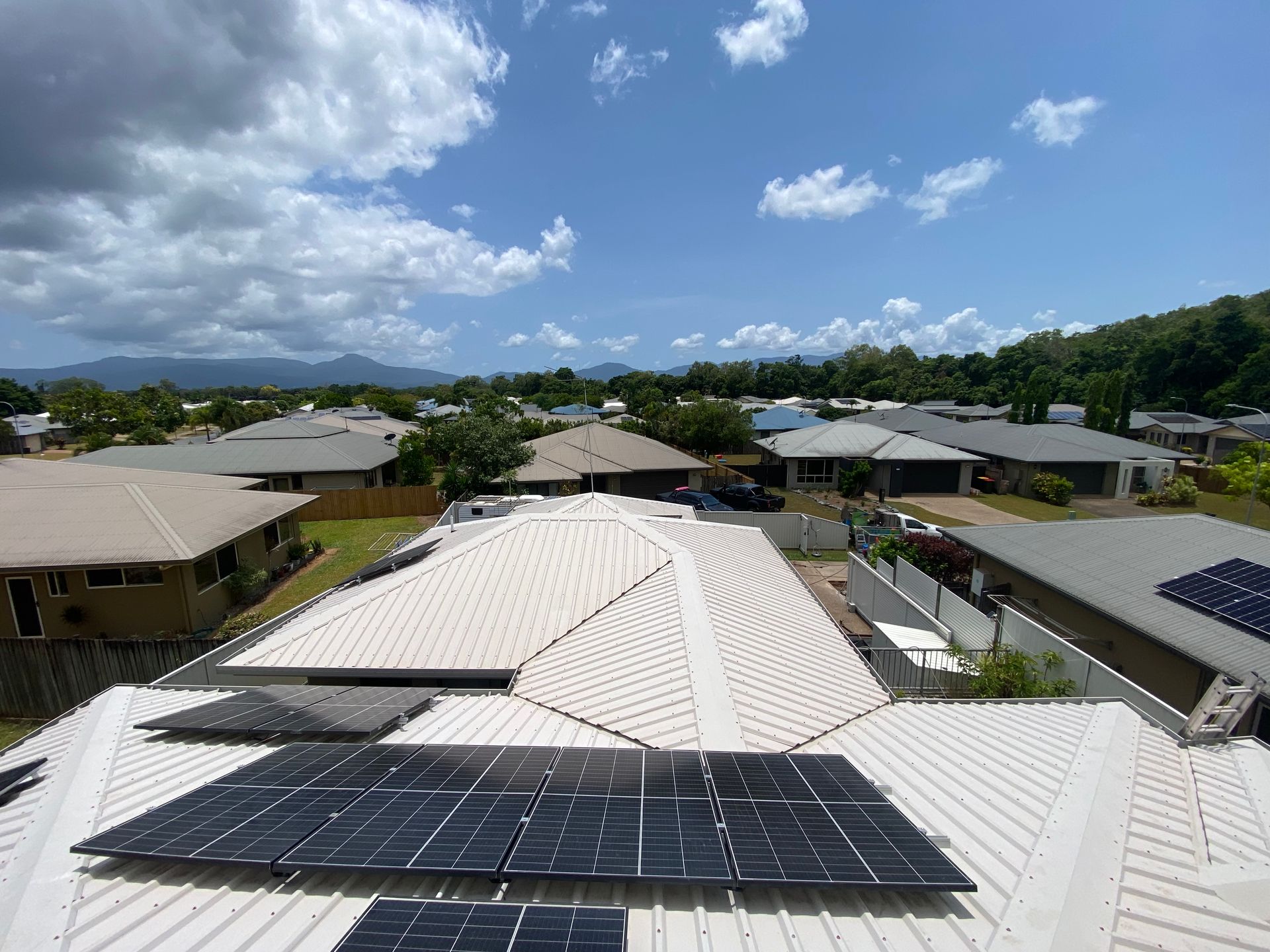 Person in Hard Hat Clean Solar Panels With Pressure Washer — Zac's Bin and Pressure Cleaning In Parramatta Park, QLD