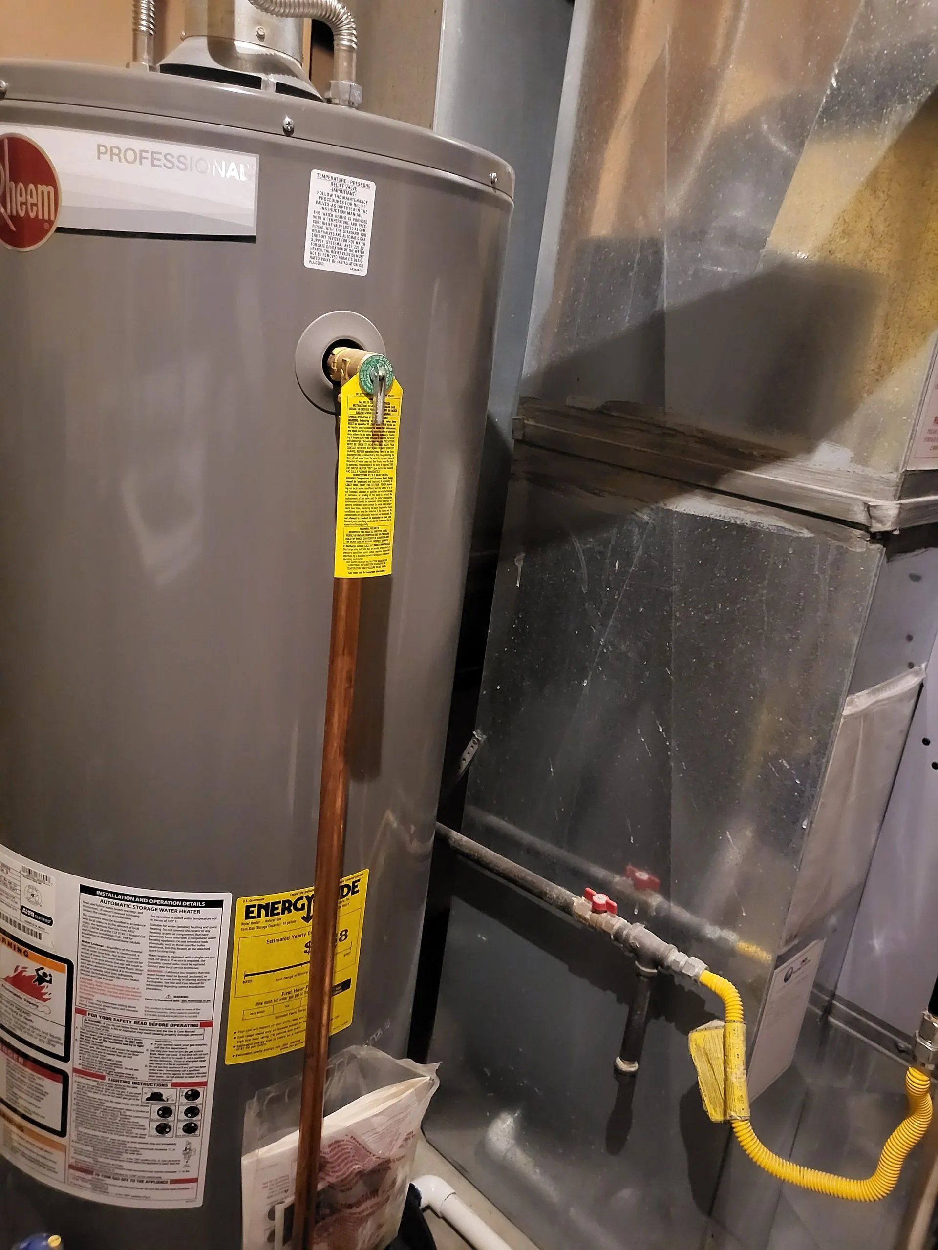Water heater and HVAC equipment in a utility closet, with yellow gas line and white venting.