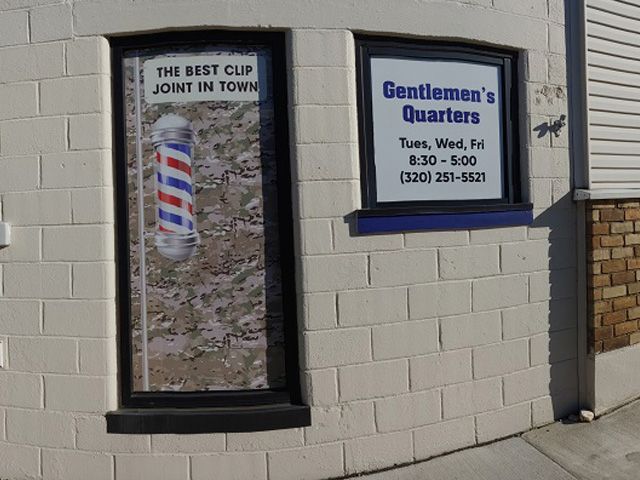 The outside of a barber shop called gentlemen 's quarters