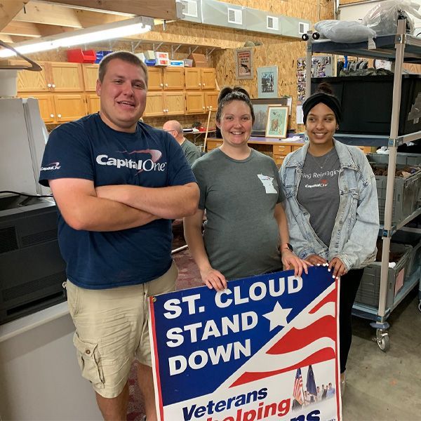 Three people holding a sign that says st cloud stand down