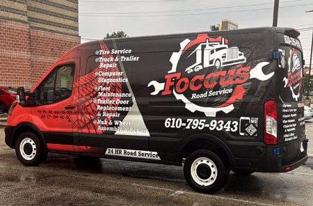 Black and red Focus Road Service van with logo and services listed. Phone number on side.