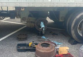 a truck is being repaired in a parking lot .