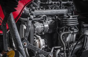 a close up of a motorcycle engine with a red tank .