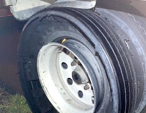 a close up of a truck tire with a hole in it .