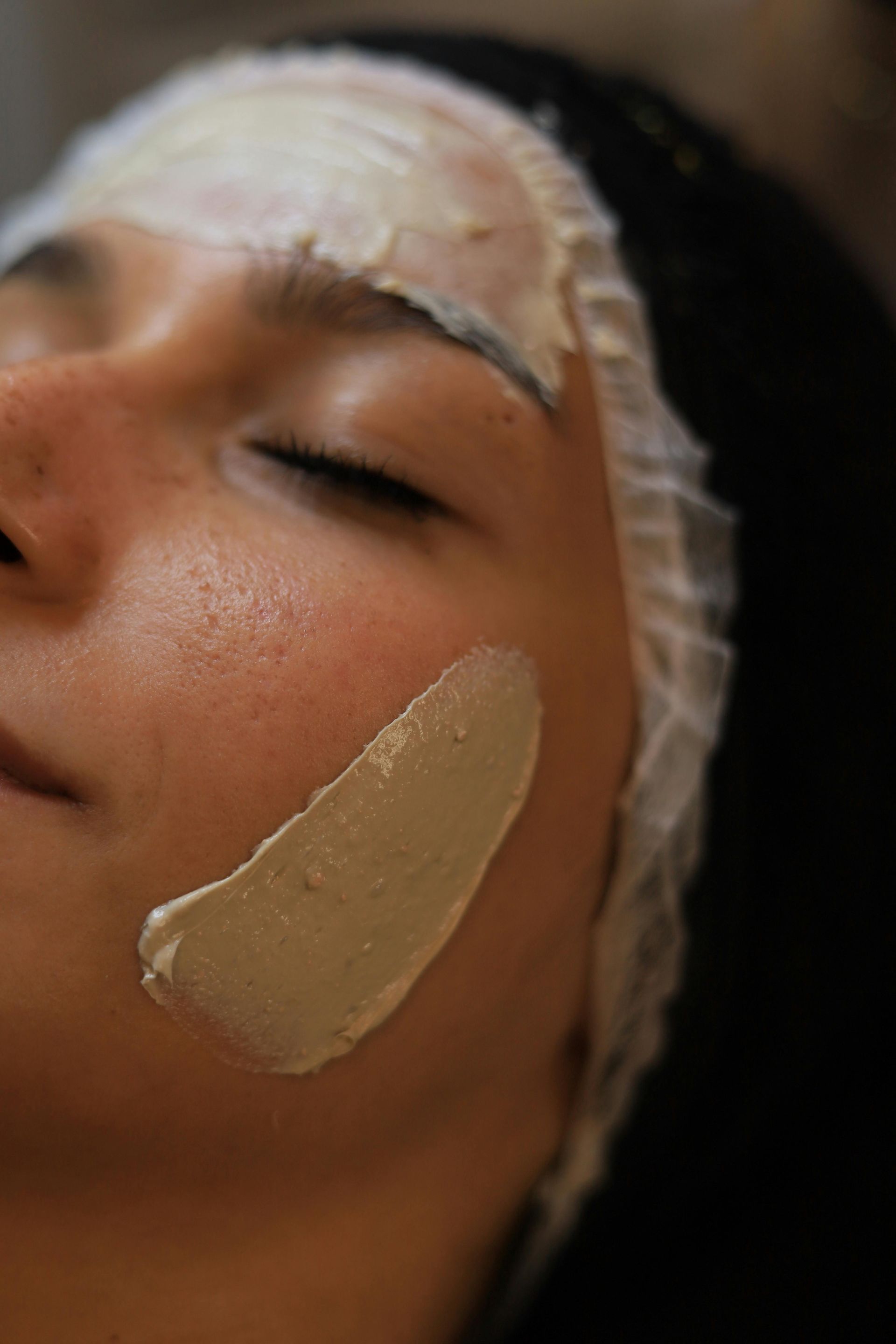 Woman Receiving Facial Treatment — Pink Lily Beauty in Blacksmiths, NSW