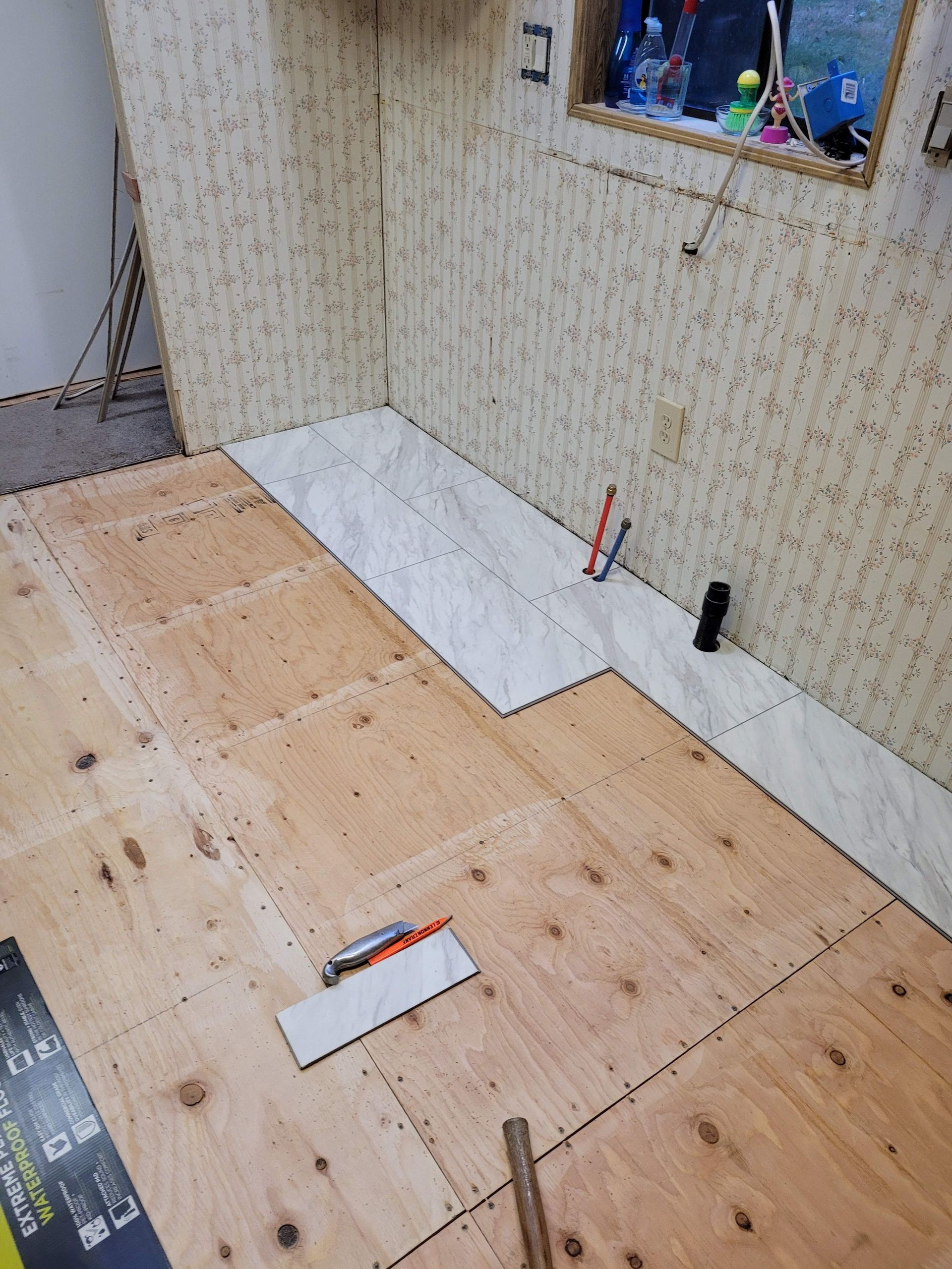 A room with a wooden floor and a window.