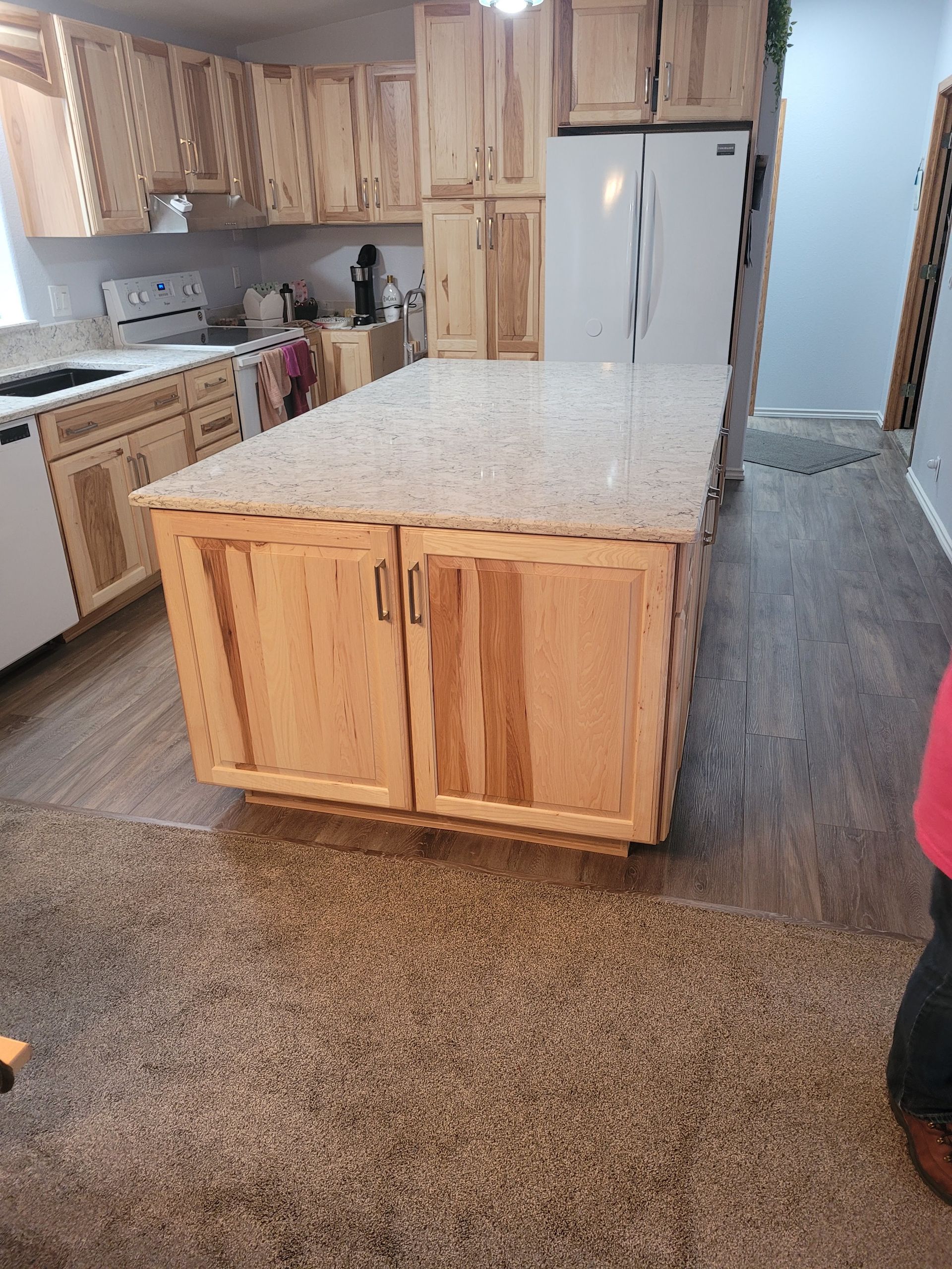 A kitchen with wooden cabinets and granite counter tops.