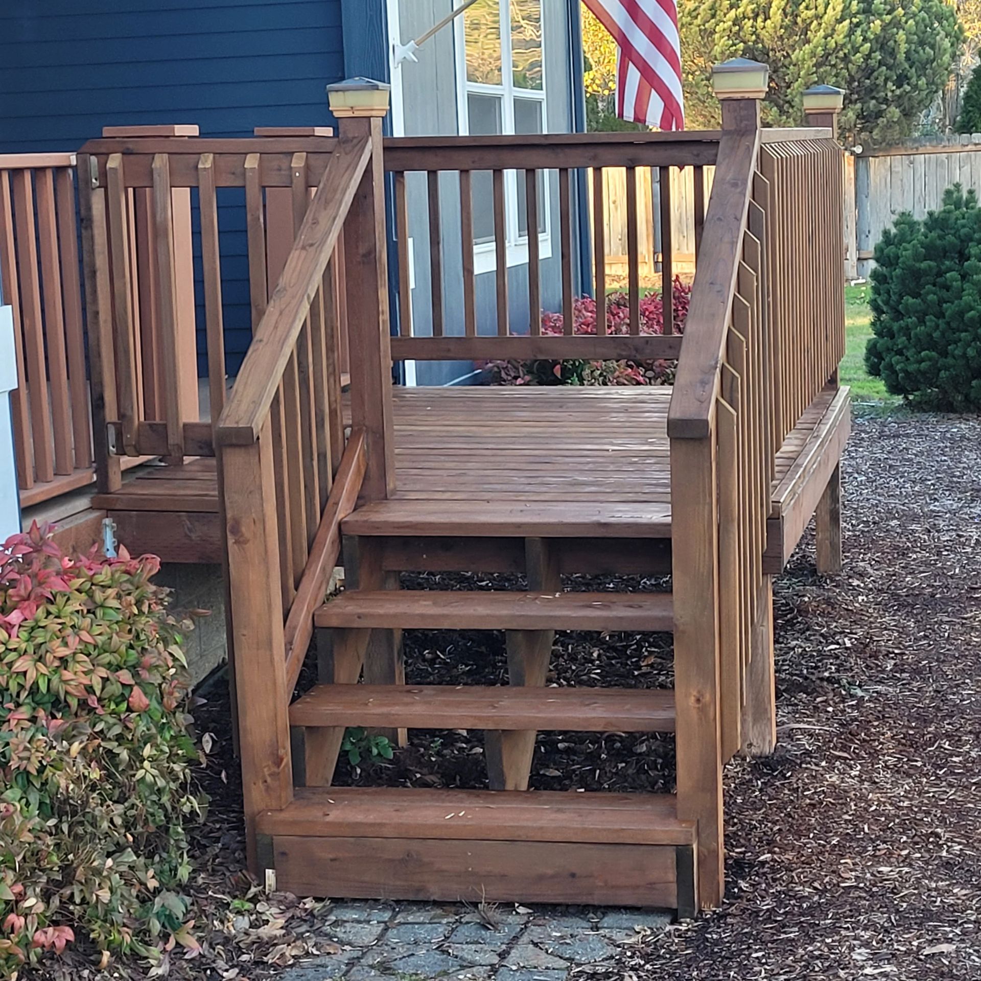 A wooden deck with stairs leading up to it