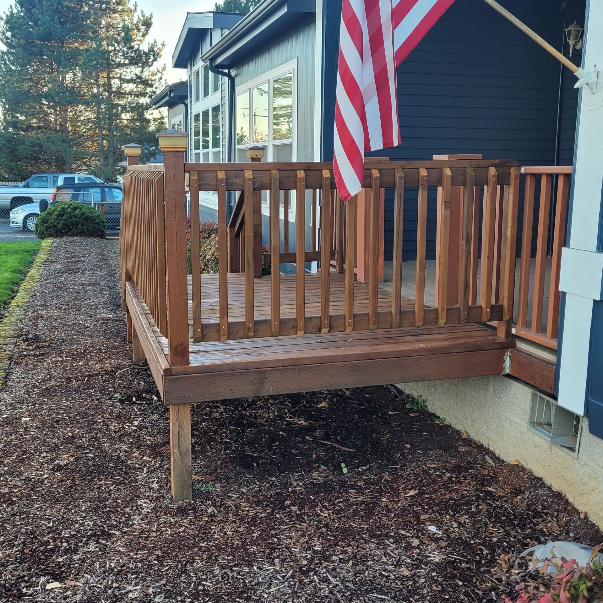 A house with a wooden deck and an american flag