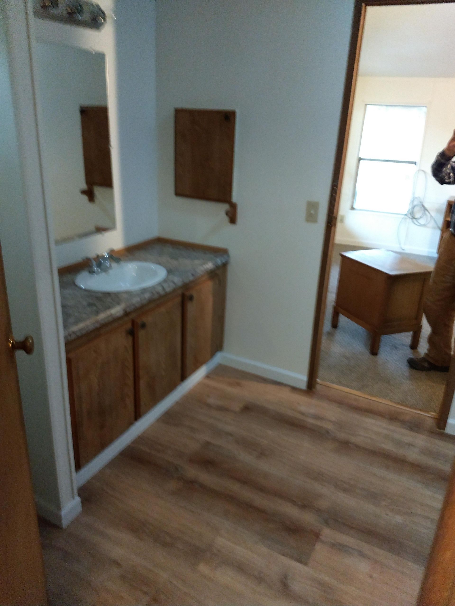 A bathroom with a sink and a mirror
