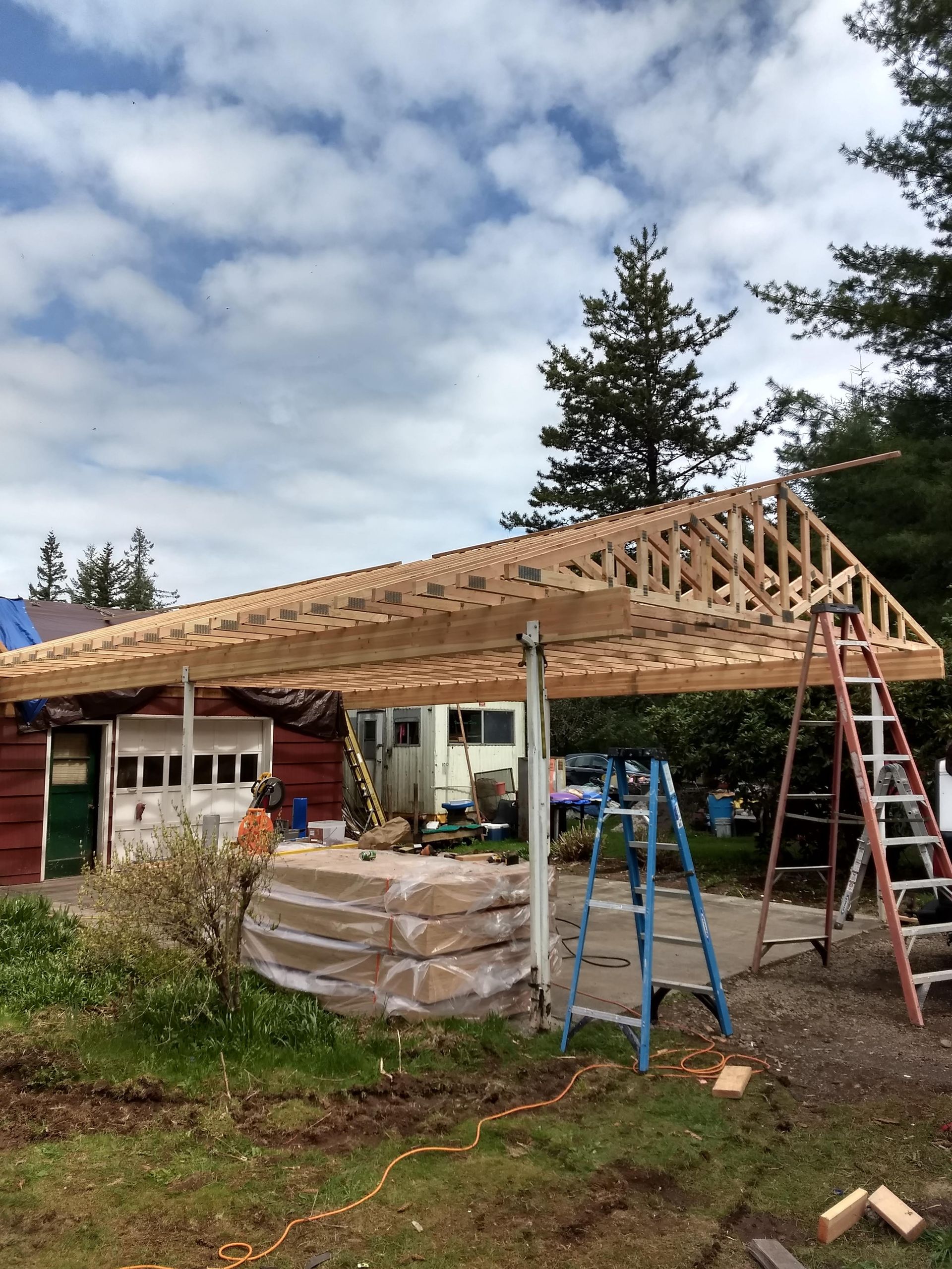 A wooden structure is being built in front of a house.