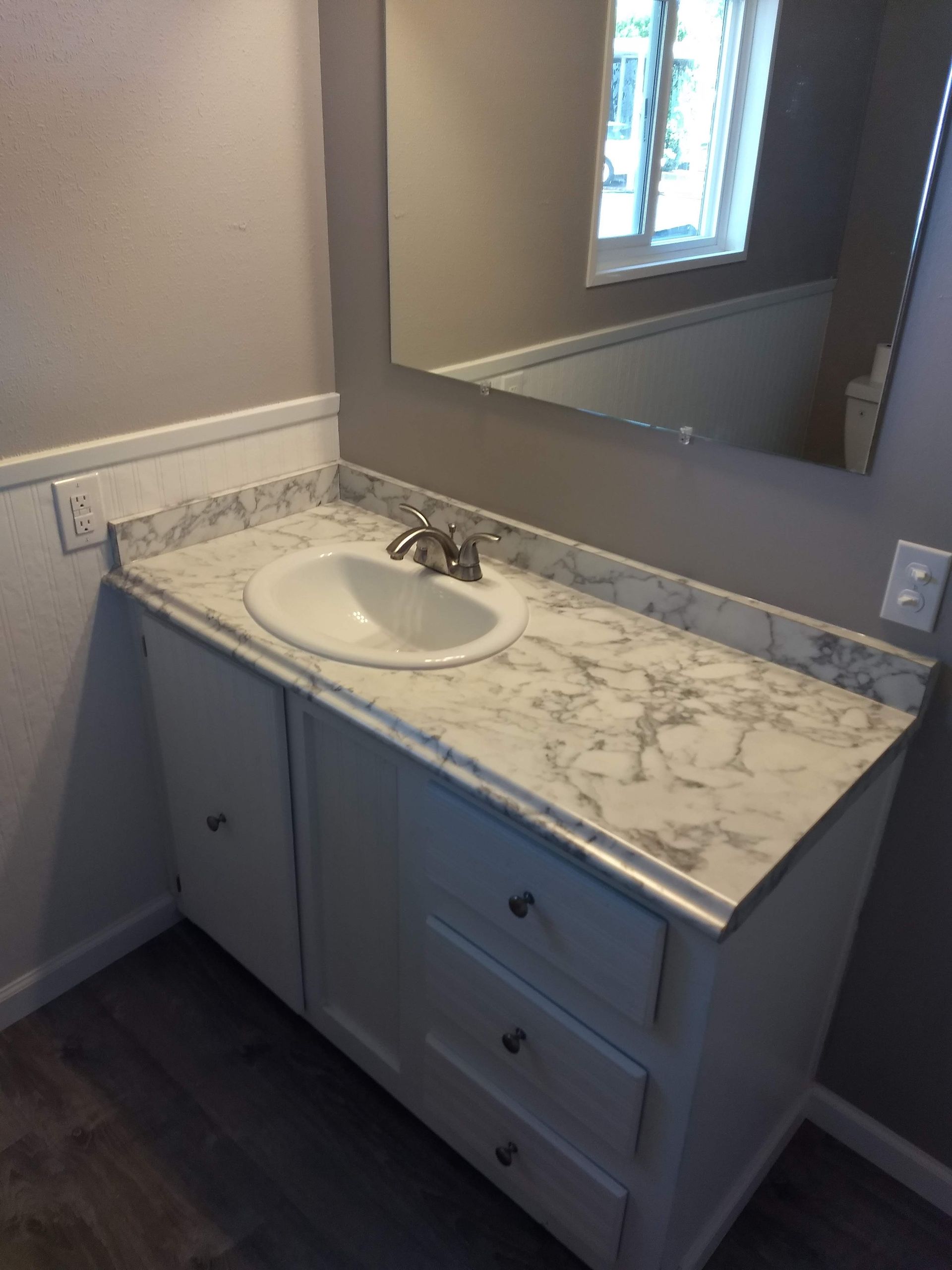 A bathroom vanity with a sink and a mirror