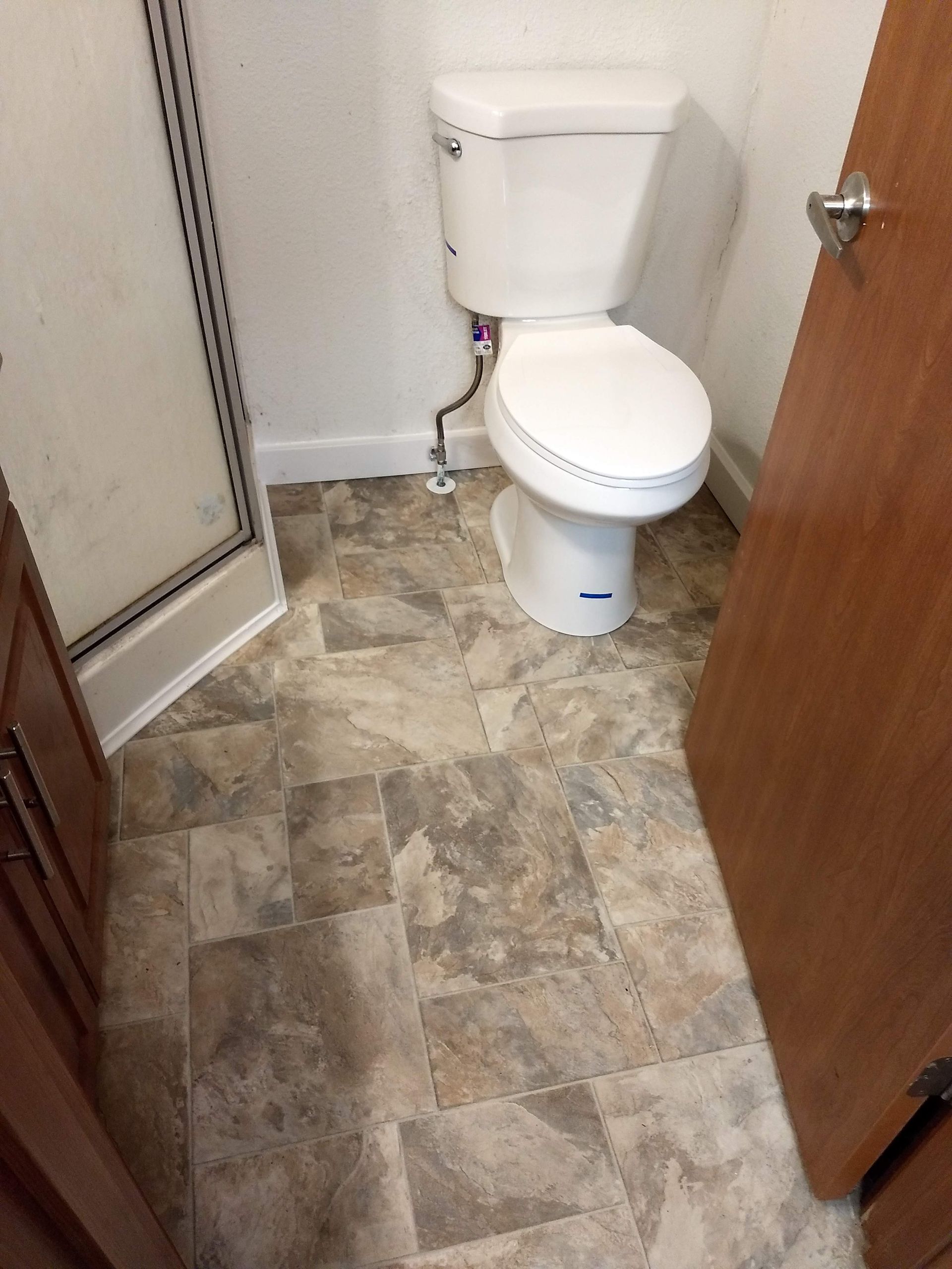 A bathroom with a toilet and a shower.