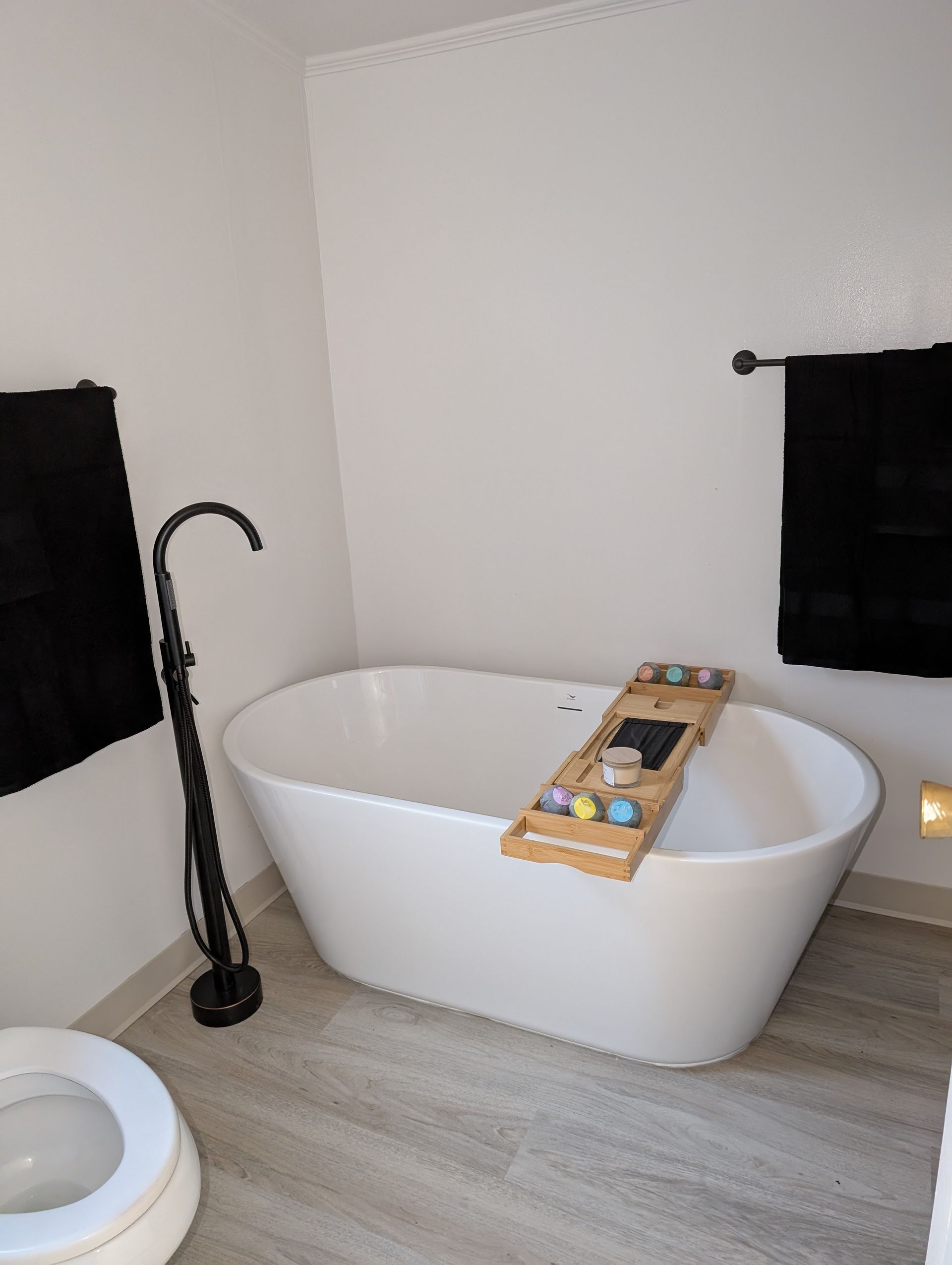 A bathroom with a bathtub and a toilet