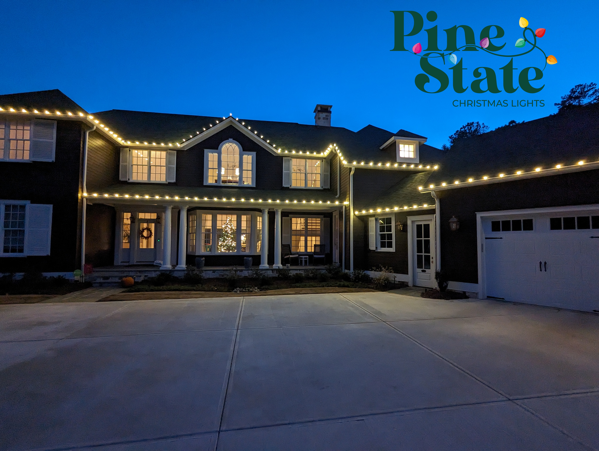 A large house with pine state christmas lights on it