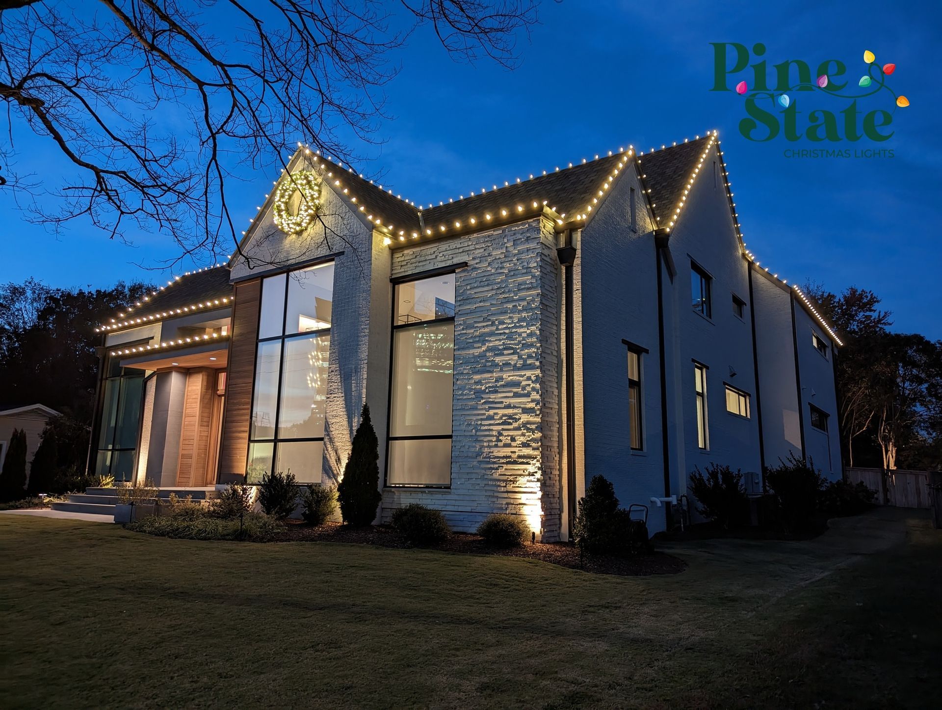 A large white house with christmas lights on it