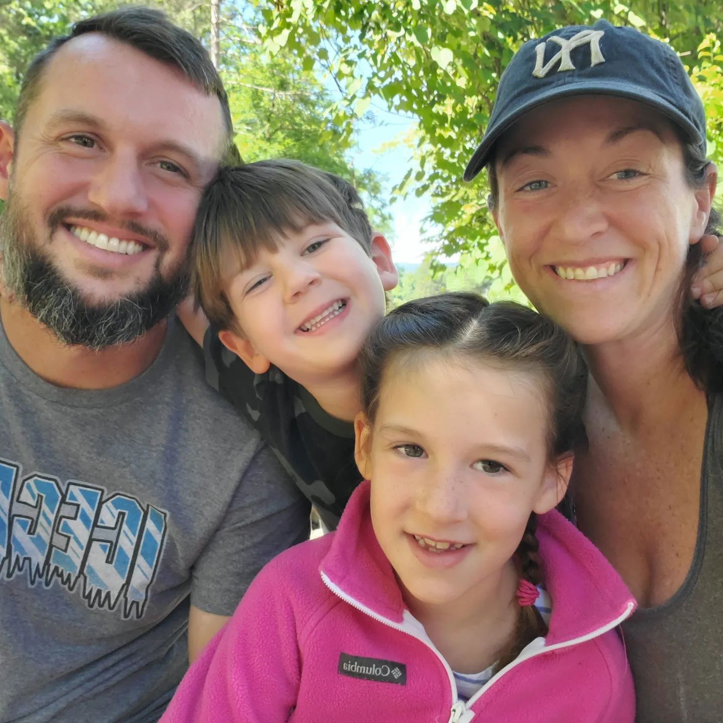 A woman wearing a hat with the letter m on it
