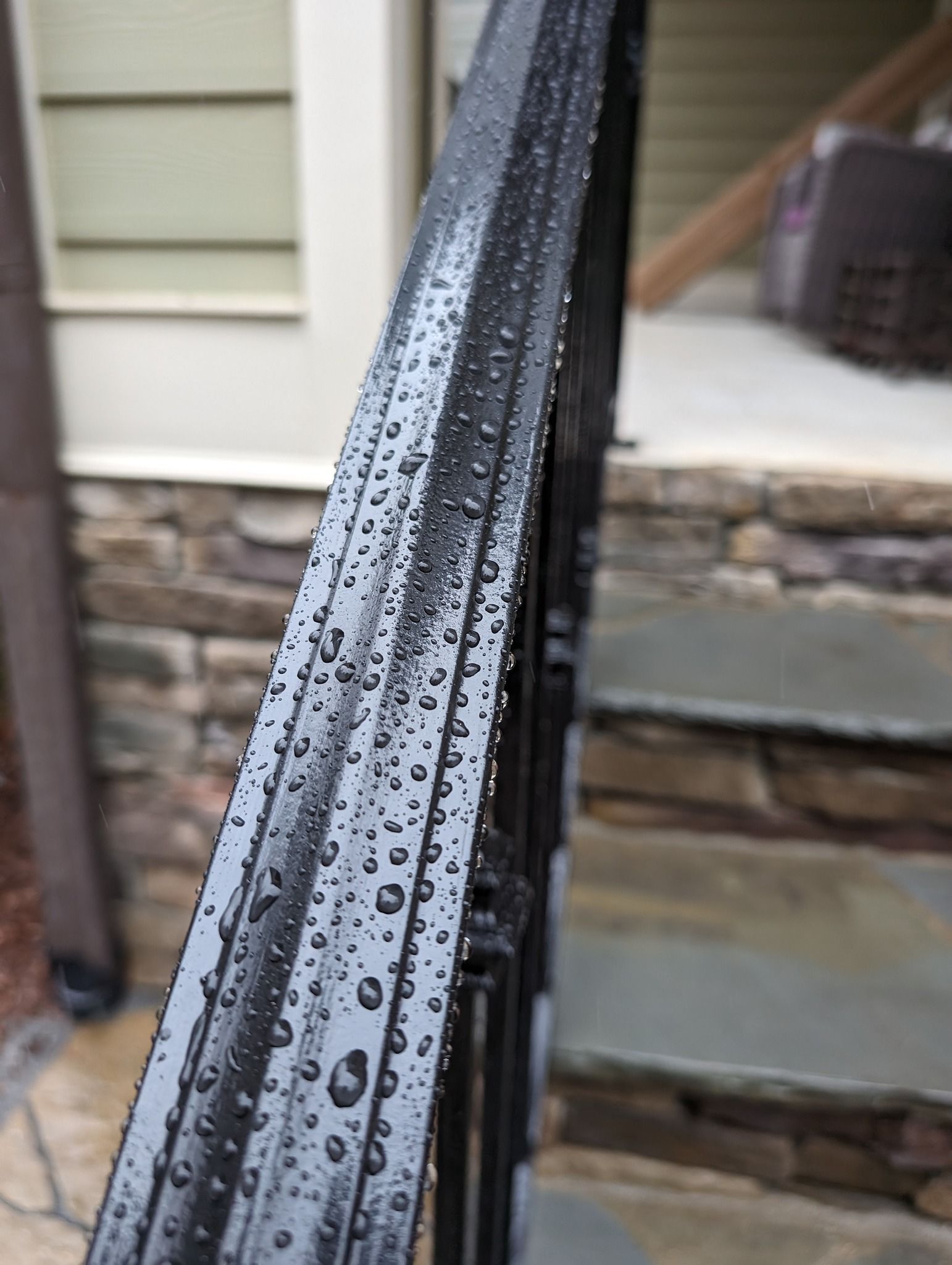 A close-up of a wrought iron railing with an enamel coating by Pine State Pro Wash in Raleigh NC