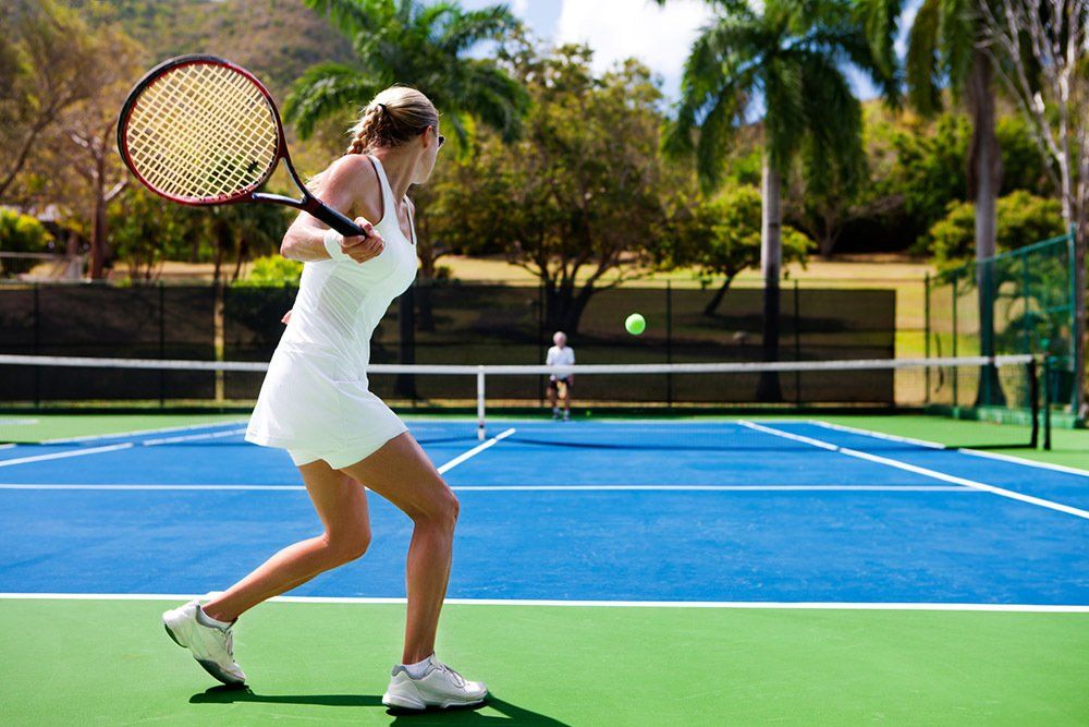 Woman Practicing Tennis — New York, NY — Athlos Management