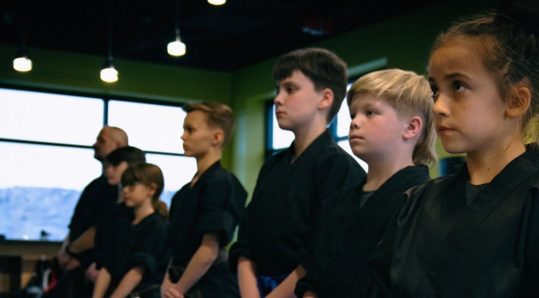 A person is holding a sparkler in their hand in the dark.