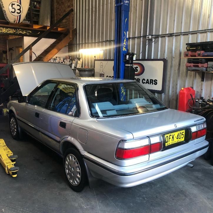A Silver Car is Parked in a Garage With the Hood Up — Coastal Automotive Services Long Jetty in Long Jetty, NSW