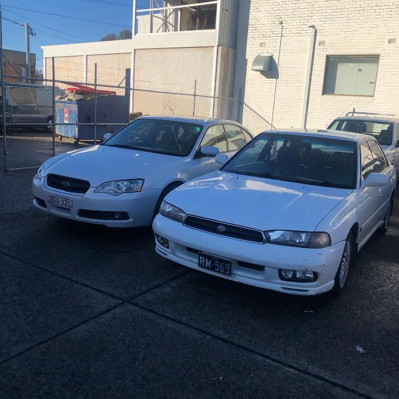 Two White Cars Are Parked Next to Each Other in a Parking Lot — Coastal Automotive Services Long Jetty in Bateau Bay, NSW