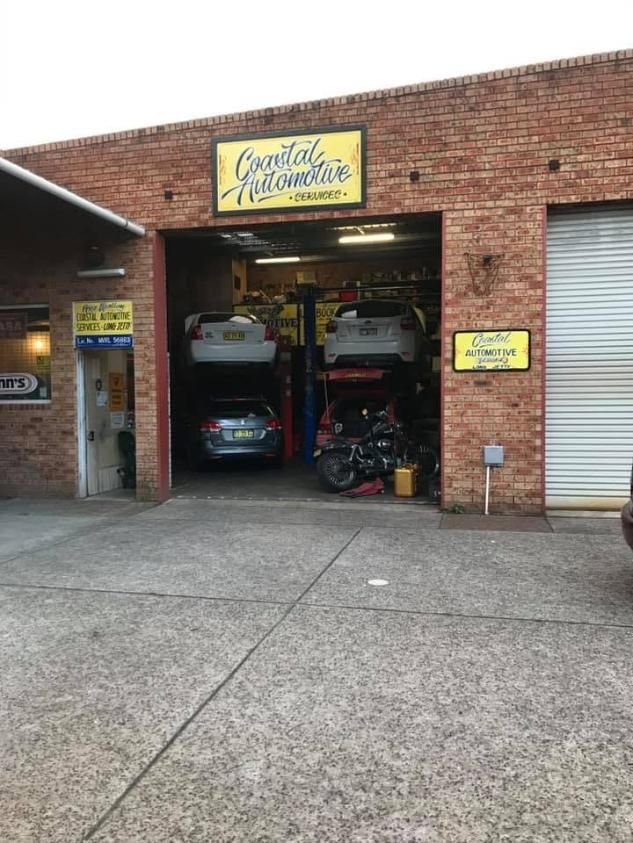A Brick Building With Cars Parked Inside of It — Coastal Automotive Services Long Jetty in Long Jetty, NSW