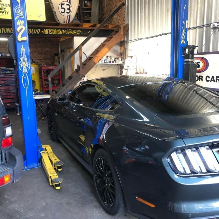 A Car on a Lift With the Number 53 on It — Coastal Automotive Services Long Jetty in Long Jetty, NSW