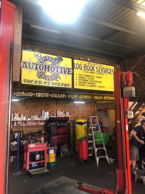 A Garage With a Sign That Says Automotive Log Book Service — Coastal Automotive Services Long Jetty in Long Jetty, NSW