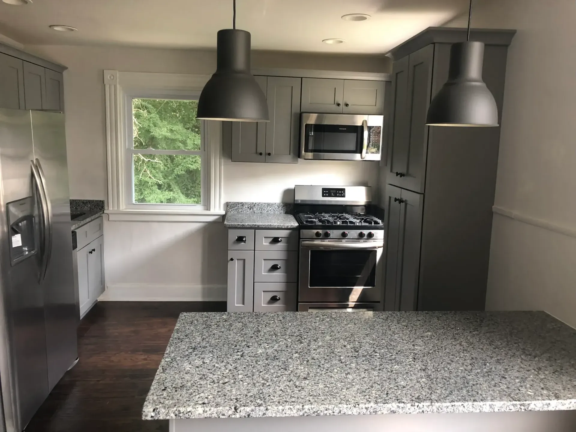 A kitchen with granite counter tops and stainless steel appliances