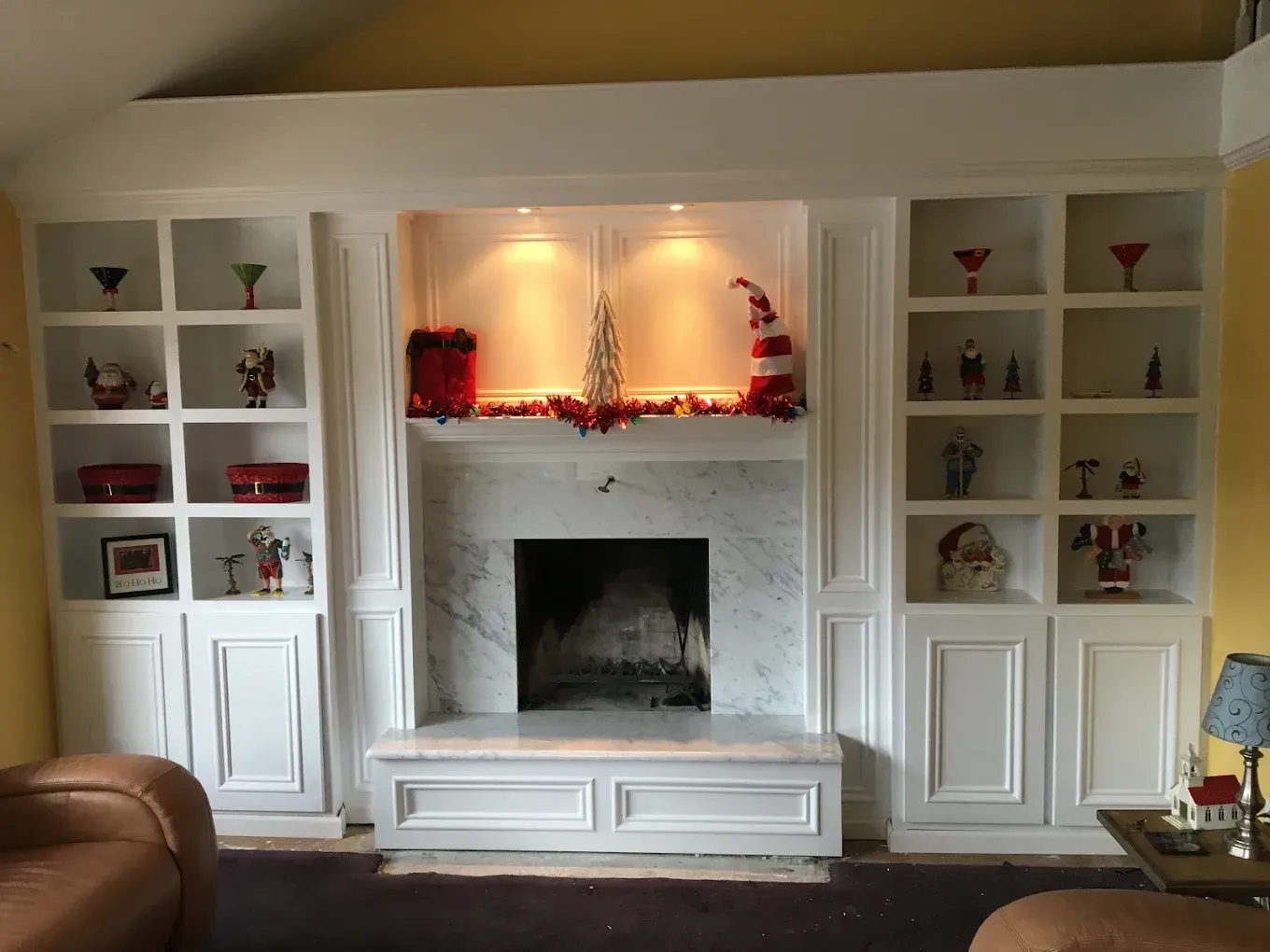 A living room with a fireplace and lots of shelves