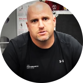 A bald man wearing a black under armour shirt