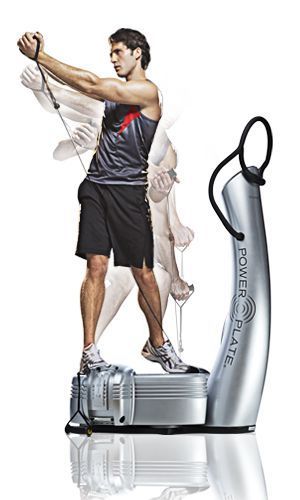 A man is standing on a power plate while holding a rope.