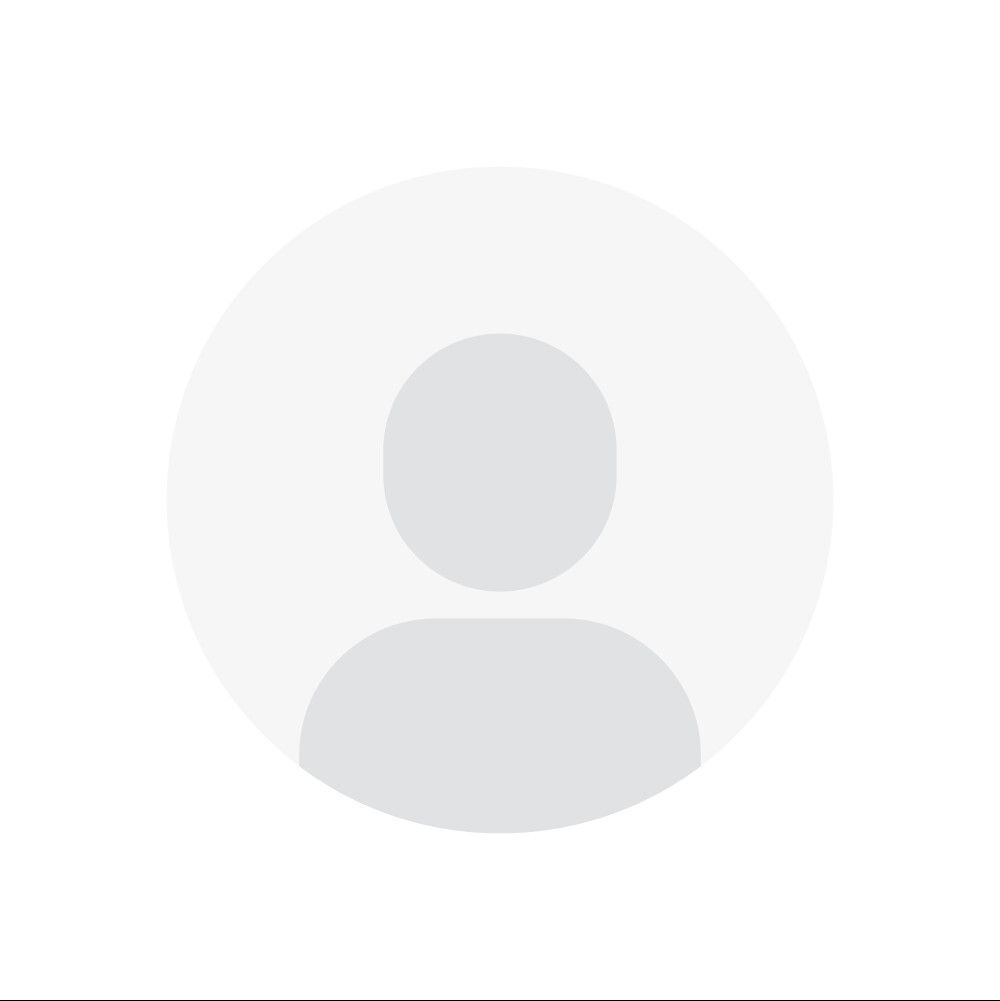 A gray circle with a picture of a person in it.