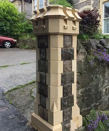 A stone column with a car parked in the background