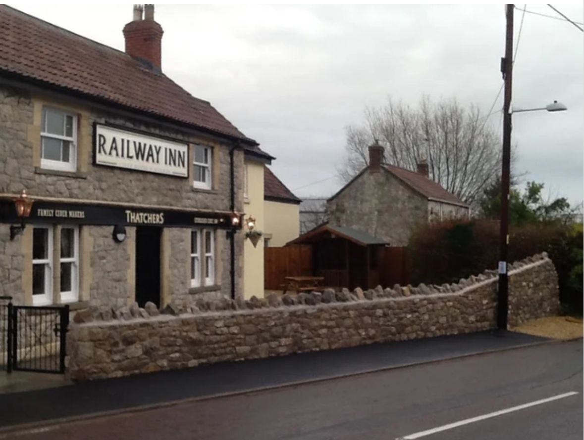 A stone building with a sign that says railway inn