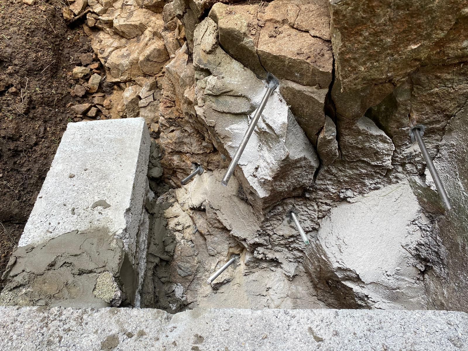 A pile of rocks and concrete is laying on the ground.