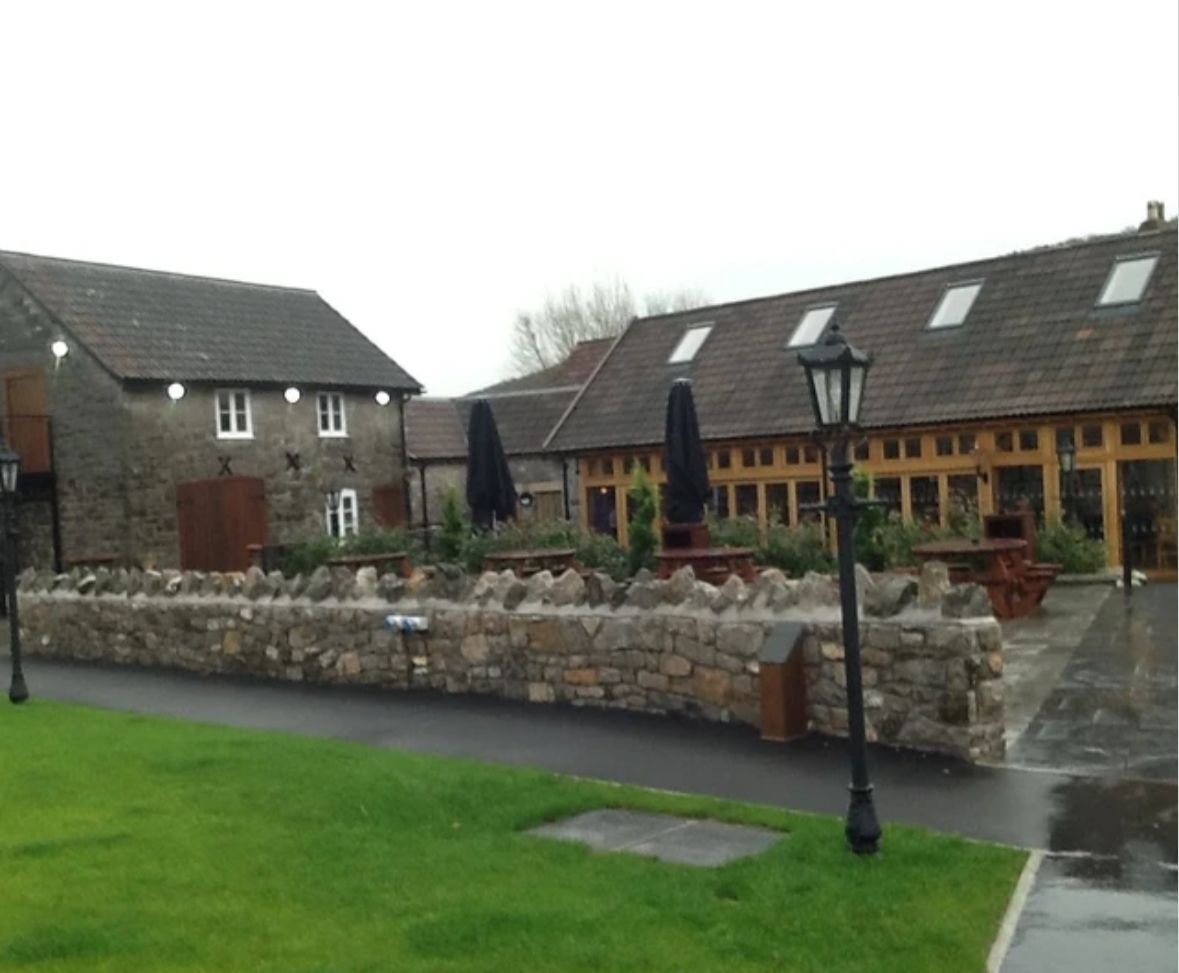A row of buildings with umbrellas in front of them