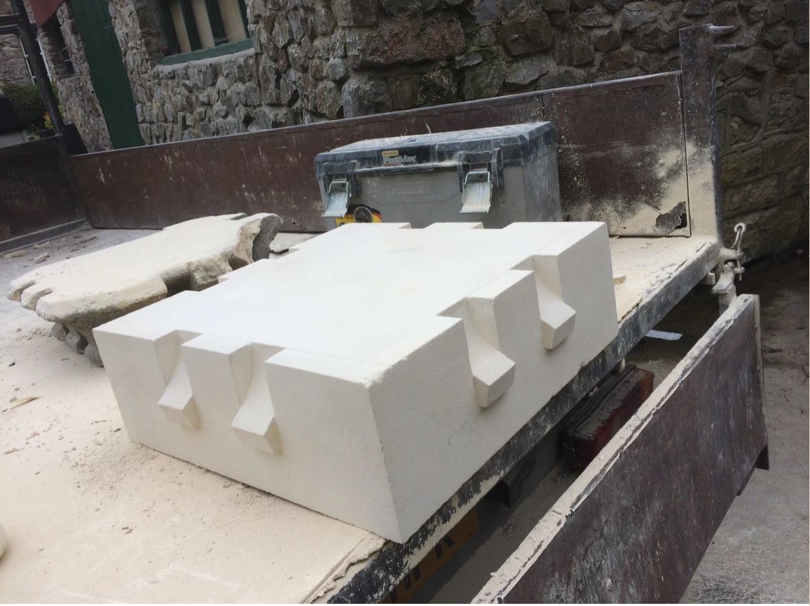 A large white block is sitting on top of a wooden table.