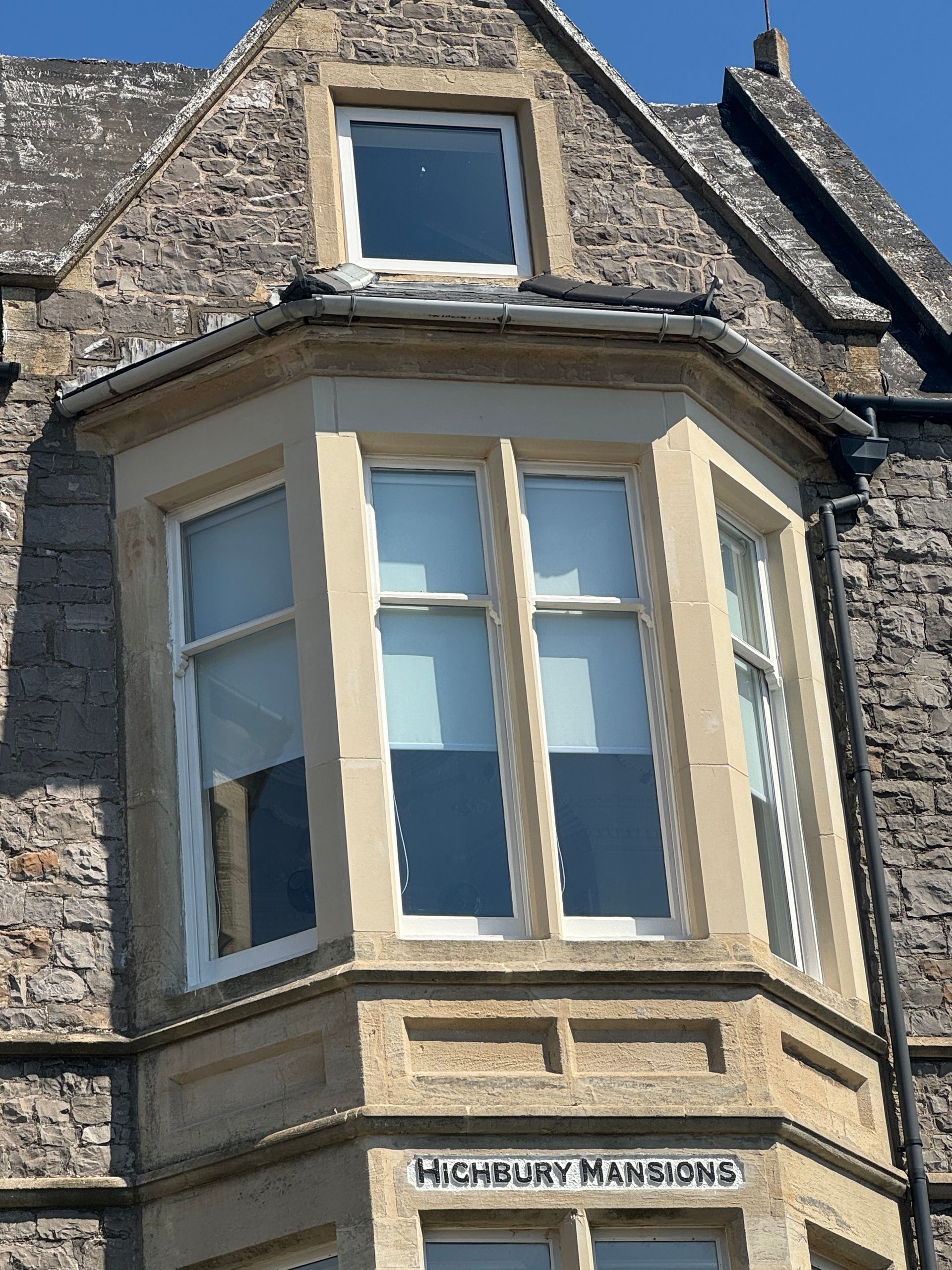 A building with a sign that says highbury mansions on it