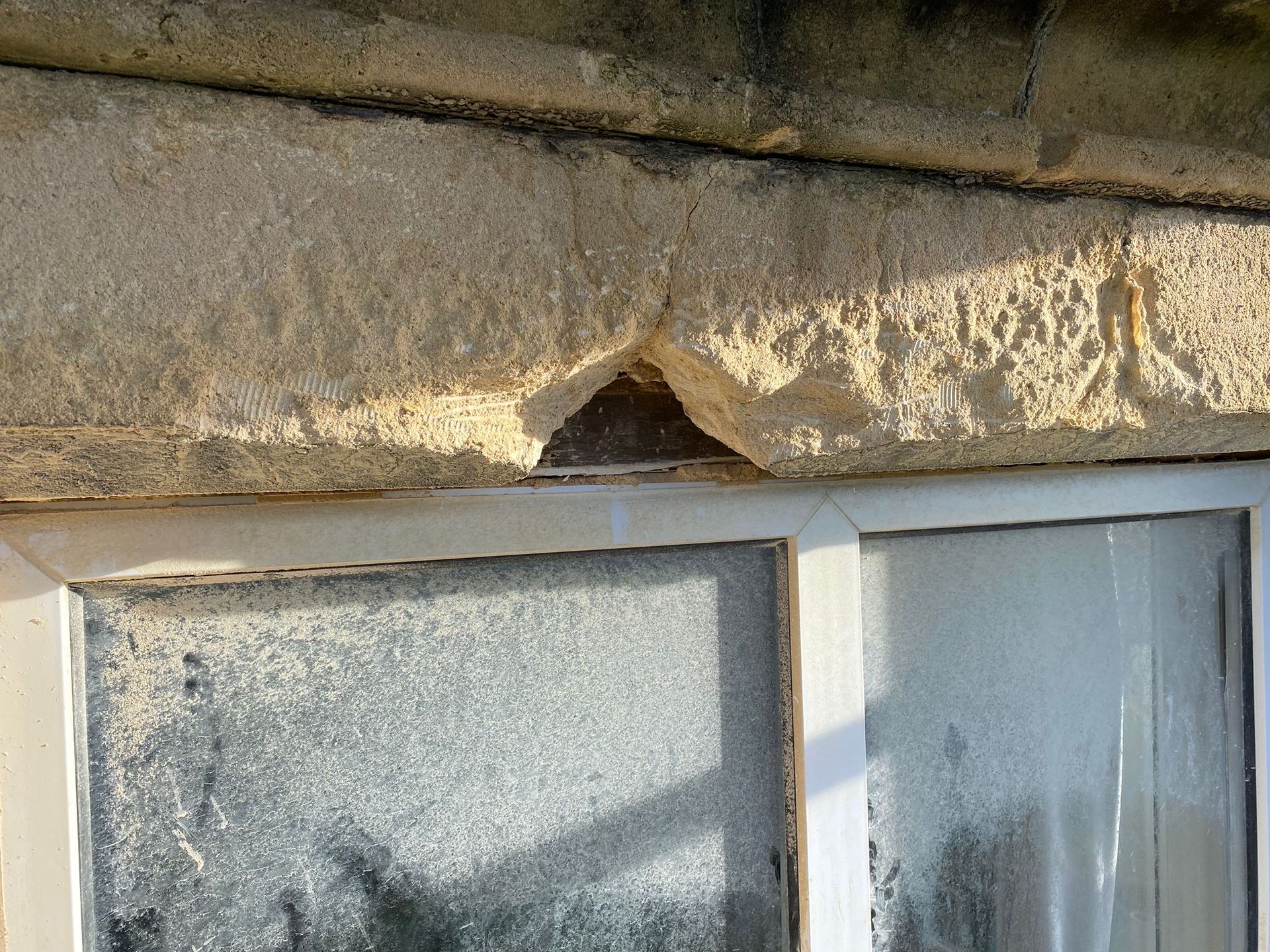 A close up of a window with a broken frame on a building.
