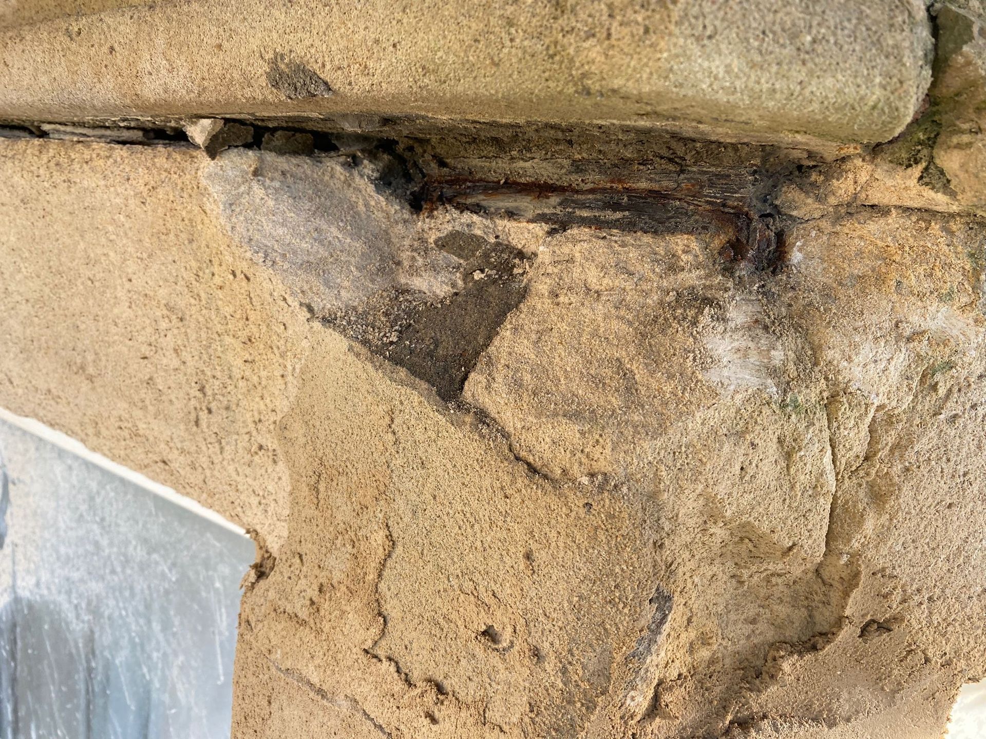 A close up of a concrete wall with a hole in it.