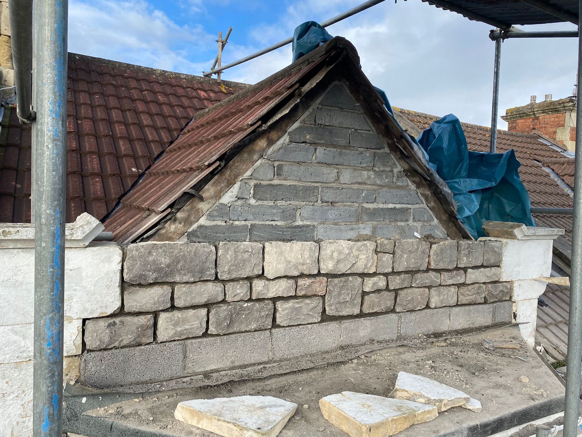 A brick wall is being built on the side of a building.