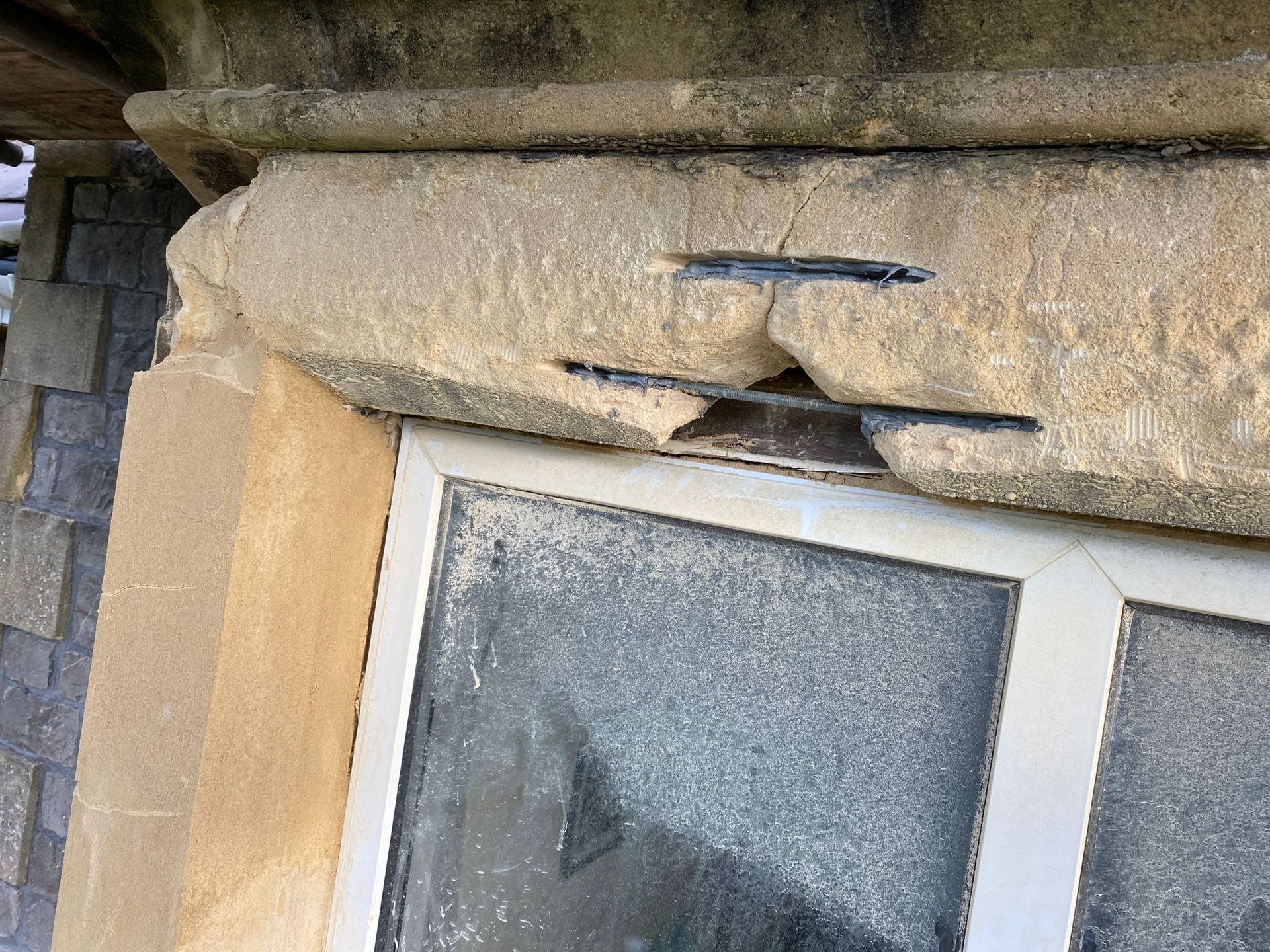 A close up of a window with a broken frame on a building.