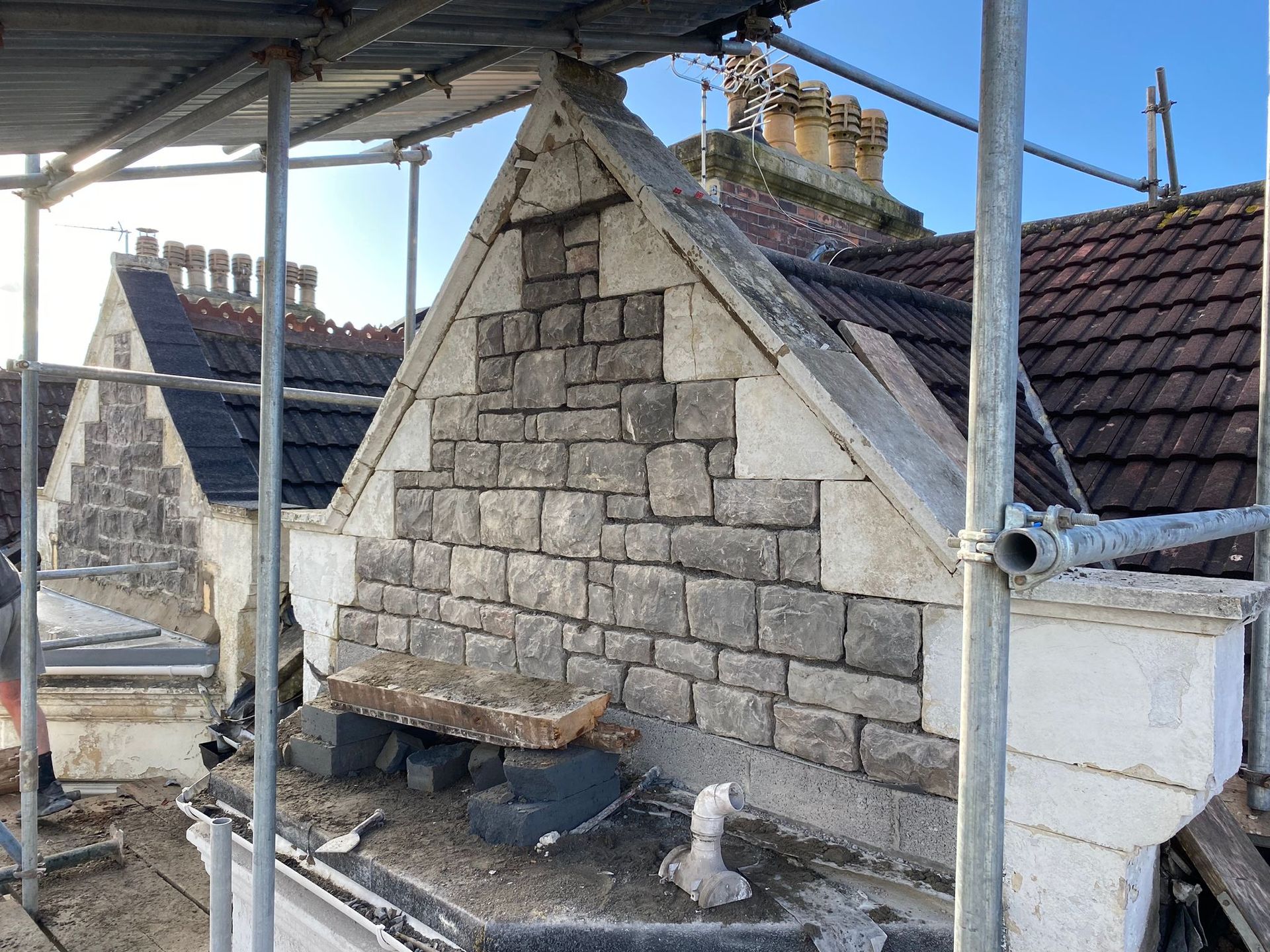 A brick wall is being built on the side of a building.