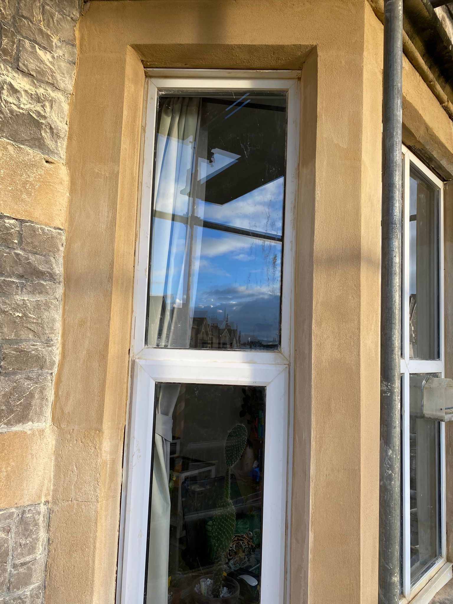 A white window on the side of a building.