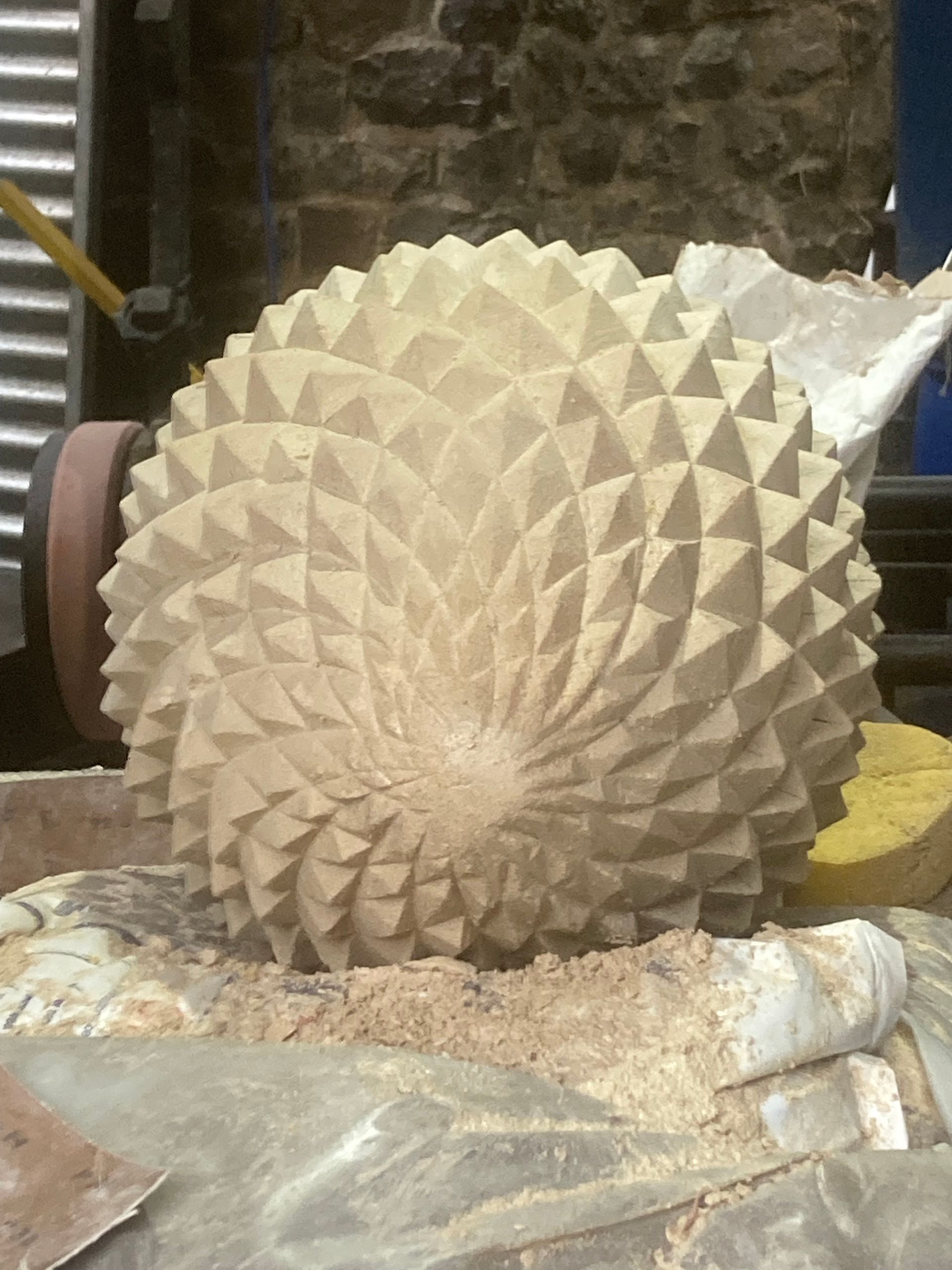 A sculpture of a hedgehog is sitting on a table